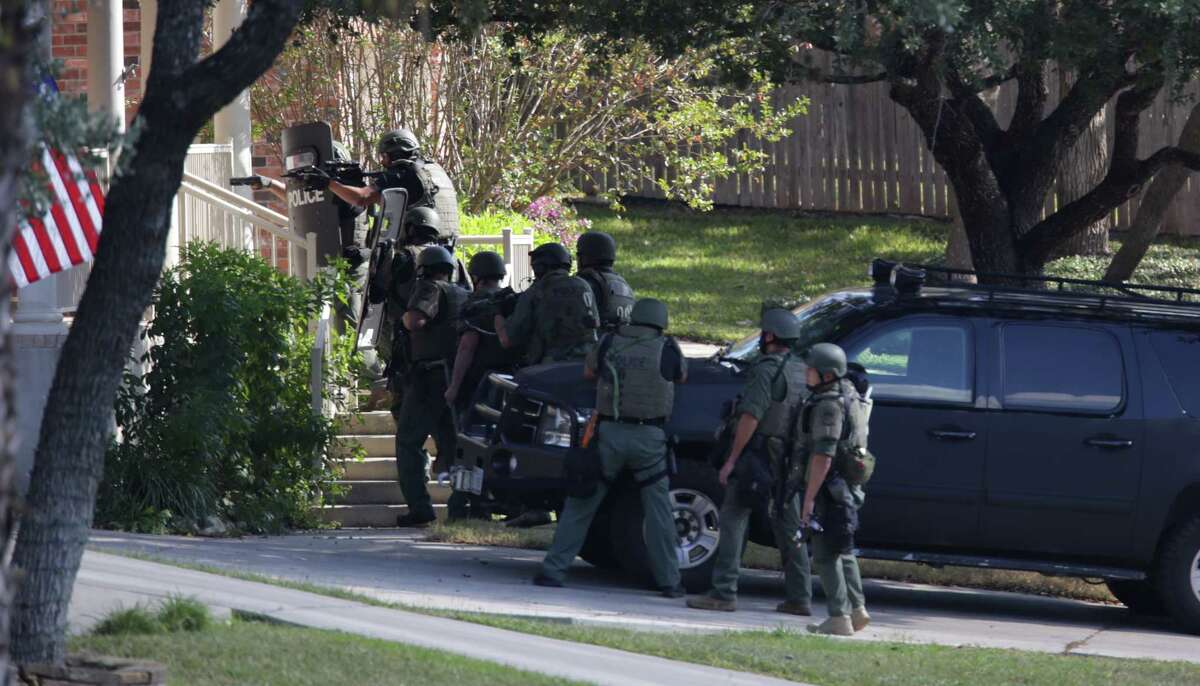 SWAT team moves to the front door of the house at 13827 Possum Tree where two shots were fired, on Monday , Nov.27, 2017.