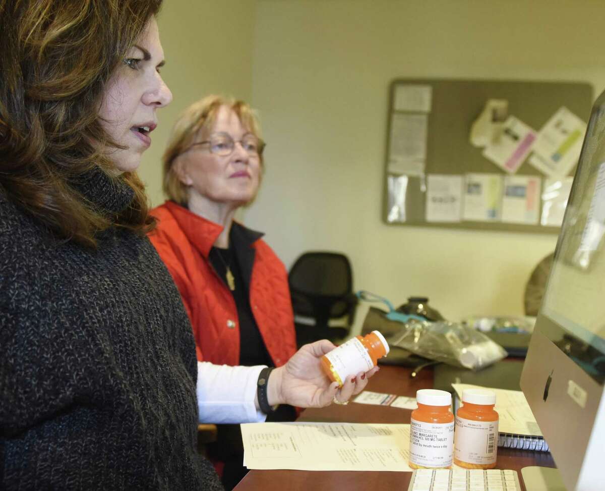 Greenwich Commission on Aging Director Lori Contadino, left, looks at Greenwich resident Margarete Catalano's prescriptions at the Medicare Part D counseling session at the Senior Center in Greenwich, Conn. Monday, Nov. 27, 2017. Presented by the Greenwich Commission on Aging, counselors helped local seniors get signed up for Medicare and find the best possible deal considering what presciptions they are on.