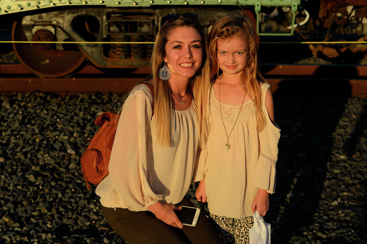 Kimberly and Skylar Everitt at the Kansas City Southern Holiday Express stop in Beaumont on Monday evening. The Christmas rail cars are traveling through six states this year, with KCS donating money to the local Salvation Army in each of the 22 cities they'll visit. Photo taken Monday 11/27/17 Ryan Pelham/The Enterprise