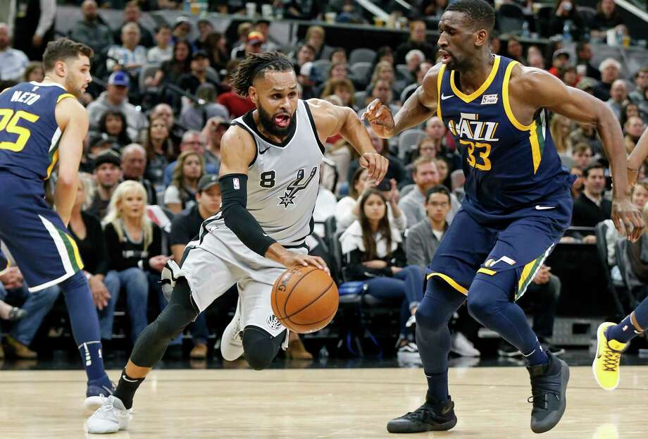San Antonio Spurs Patty Mills Drives Between Utah Jazzs Raul Neto Left And San Antonio Spurs Patty Mills Drives Between Utah Jazzs Raul Neto Left And