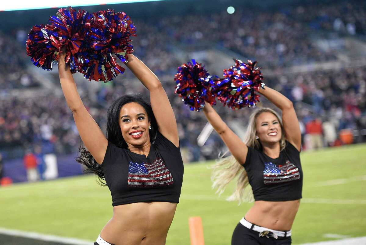 Baltimore Ravens cheerleaders perform during an NFL football game between t...