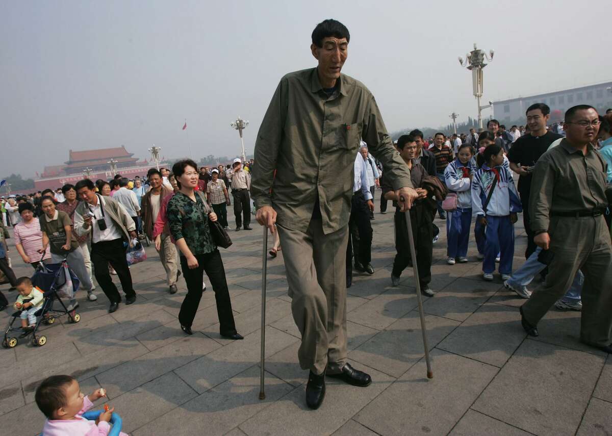 Bao Xishun, a Chinese man who measures 2.361 meters (about 7 feet 8 inches) walks during a sightseeing event at the Tiananmen Square September 27, 2005 in Beijing, China. 55-year-old Bao, a herdsman from Inner Mongolia Autonomous Region, was officially declared as the world's tallest naturally-growing human during a ceremony by the headquarters of Guinness World Records in London on September 22.