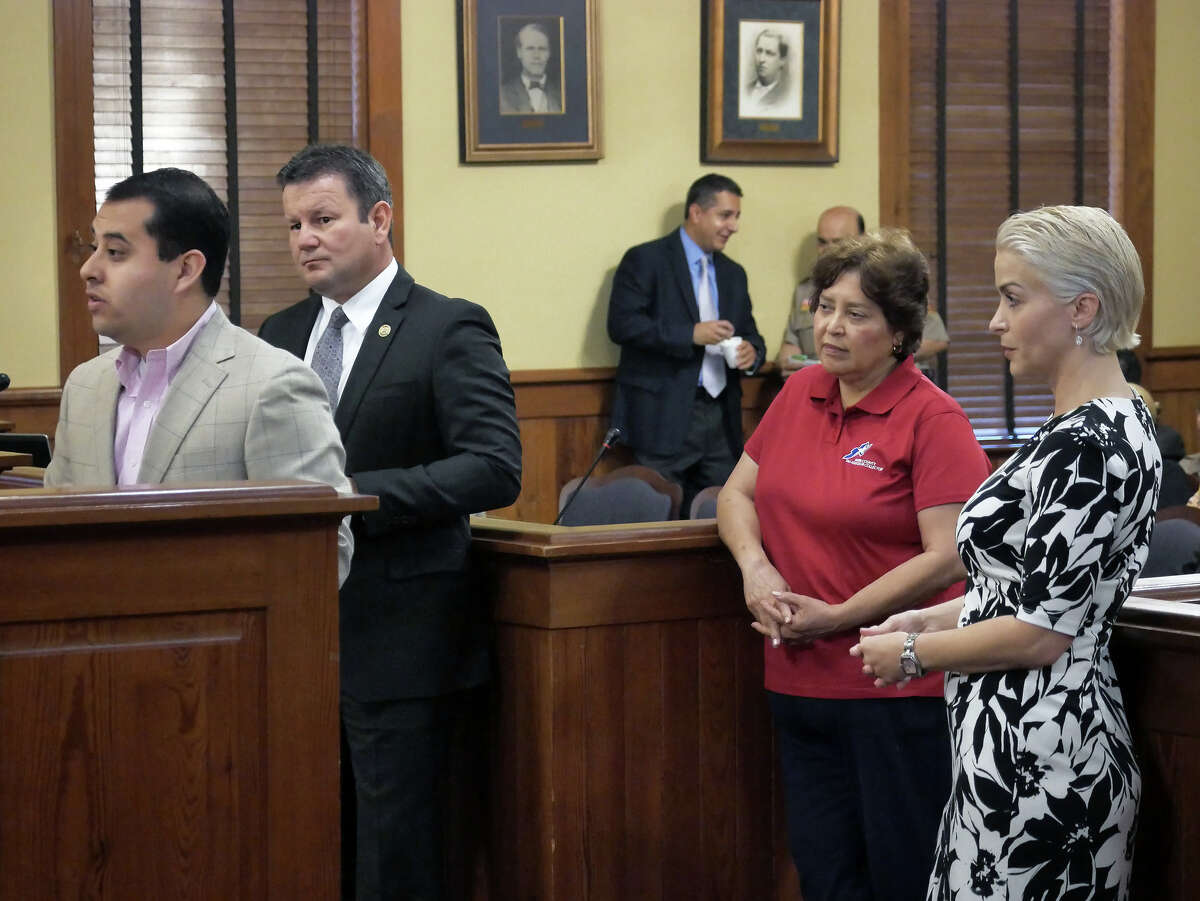 Former Webb County Tax Collector/Assessor Patricia Barrera, third from left, and county officials Leroy Medford and Alexandra Colessides Solis listen as Webb County Democratic Chairman Alberto Torres Jr., addresses county commissioners Monday, November 27, 2017, regarding Barrera's resignation. Commissioners approved Barrera's resignation and appointed Norma C. Farabough as interim Tax Assessor Collector.