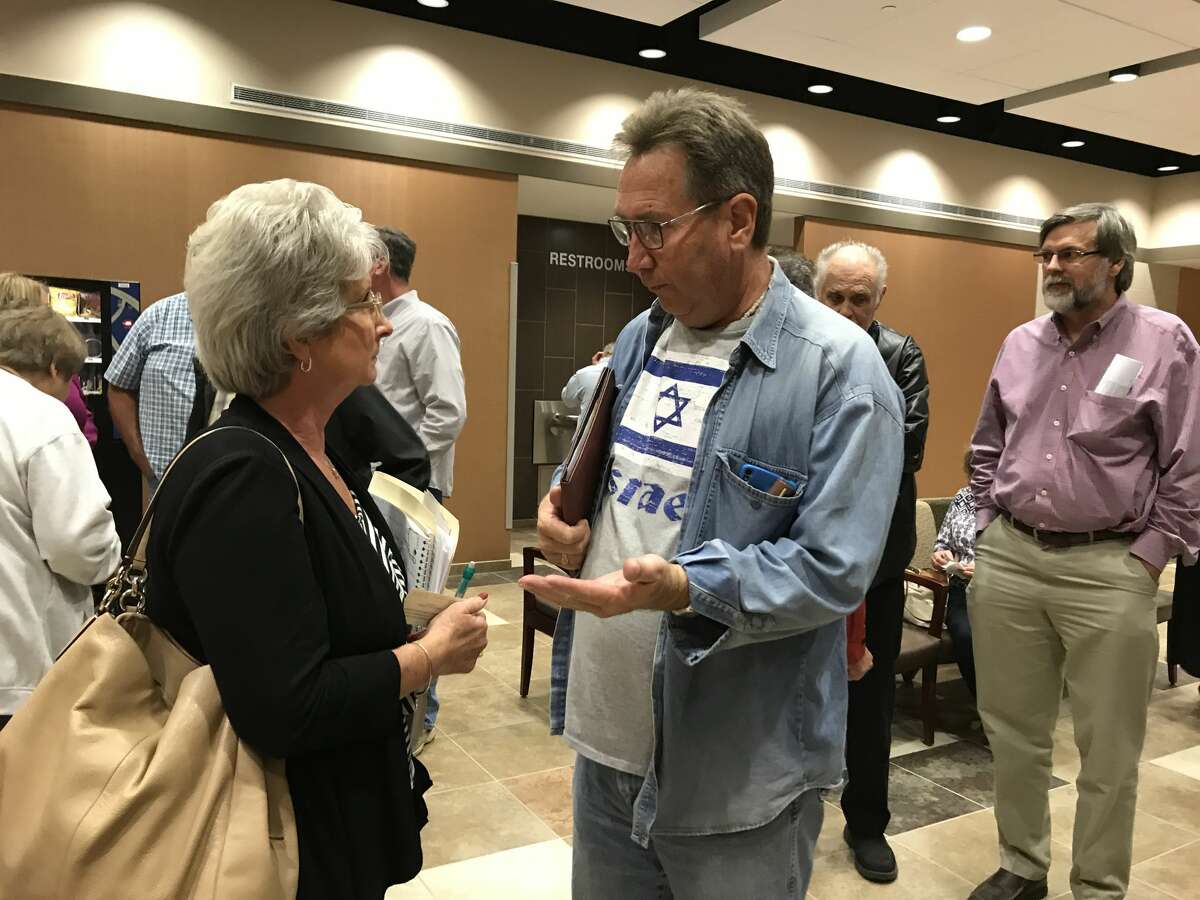 Michele Falzon owns property in two areas targeted by Pearland. One was annexed Monday night and the other was taken off the agenda due to a temporary restraining order granted by a judge. Others pictured are property owners in county areas that were annexed Monday night at Pearland City Hall.