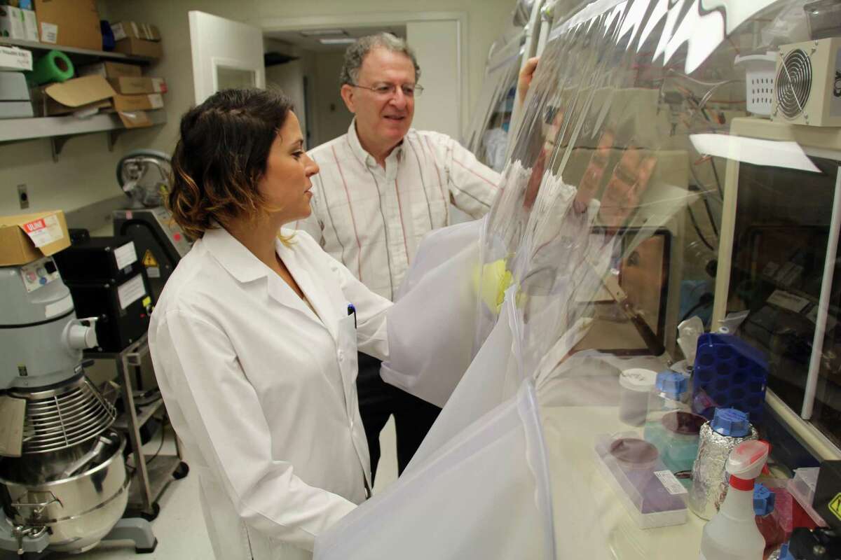 At the Washington University School of Medicine in St. Louis, Dr. Jeffrey Gordon and graduate student Vanessa Ridaura examine samples of gut bacteria taken from fat or lean people in 2013. Such research on obesity might be thwarted if fewer graduate students exist because their tuition aid will be taxed.