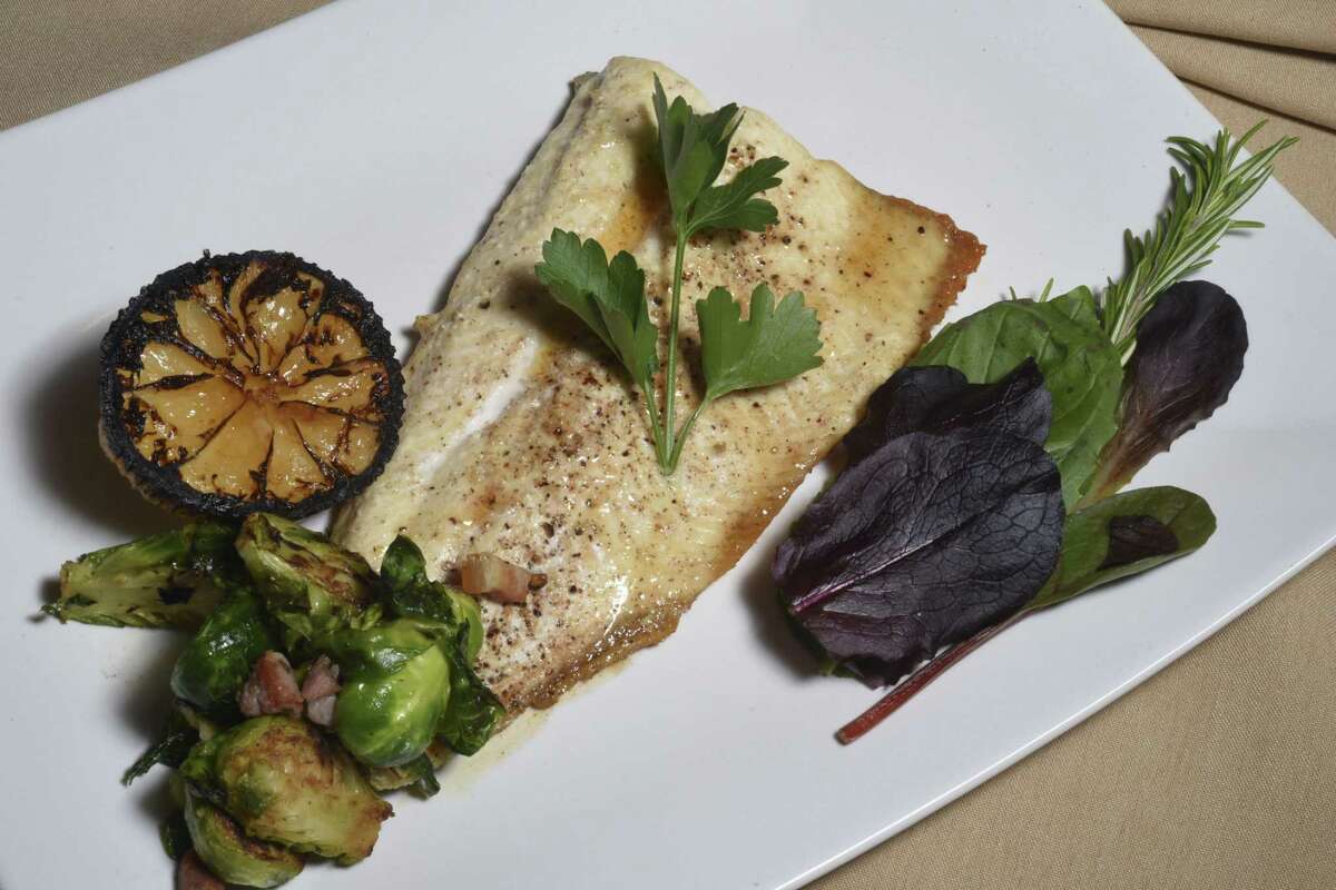 Idaho trout with hazelnut, brown butter and pancetta and roasted Brussels sprouts at Rossini Italian Bistro in 2016.