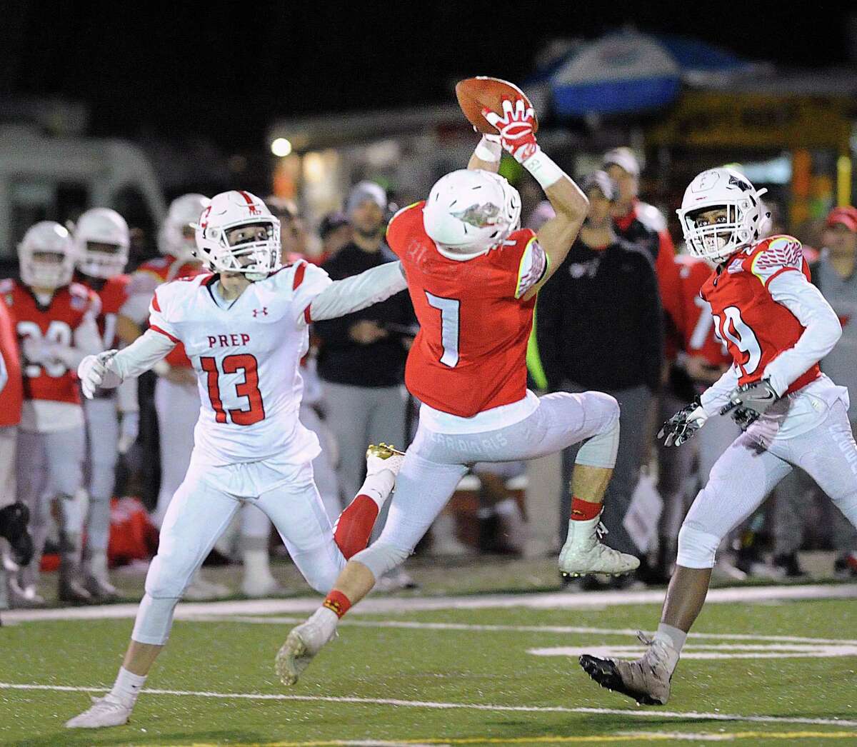 At center, Greenwich defender Charlie Ducret (#7) made an interception as he stepped in front of Fairfield Prep receiver Christopher Duffy (#13), at left, during the first quarter of the Class LL high school football playoff game between Greenwich High School and Fairfield Prep at Greenwich, Conn., Tuesday, Nov. 28, 2017.