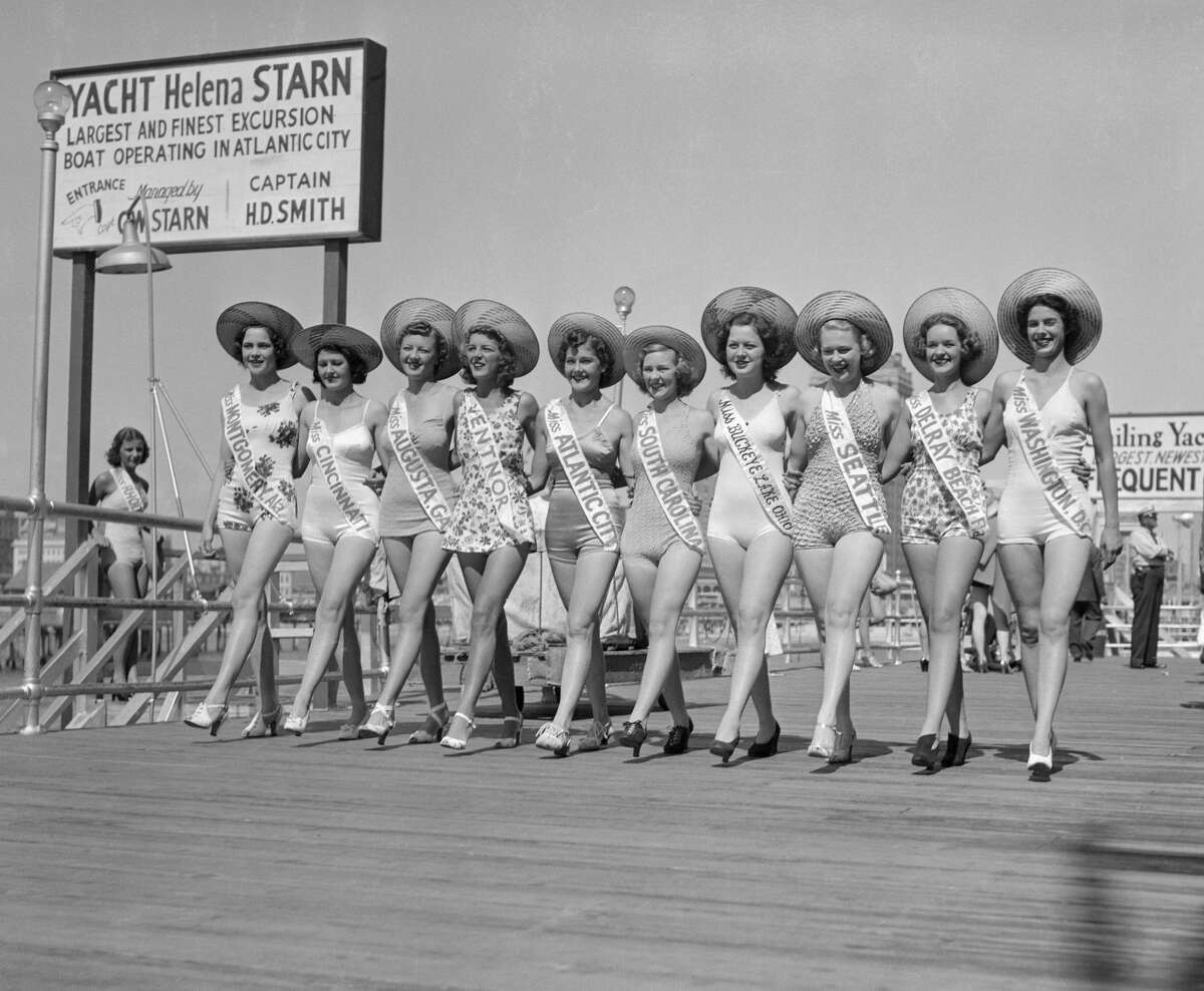 "Pictured wearing the hats given them by Malen Pietrantoni, "Miss Puerto Rico", are a group of beauties who are entered in the "Miss America" contest. ... The girls are, Almeda Starkey, "Miss Montgomery"; Sally Julian Frank, "Miss Cincinnati"; Miss Augusta"; "Miss Ventnor"; "Miss Alantic City", Charlotte Velez; Dallas J. Wilson, "Miss South Carolina"; Evelyn Townley, "Miss Buckeye Lake"; "Miss Seattle"; "Miss Del Ray Beach" (FLA); Helen Greene, "Miss Washington". Yes, hello Miss Seattle, whoever you are.
