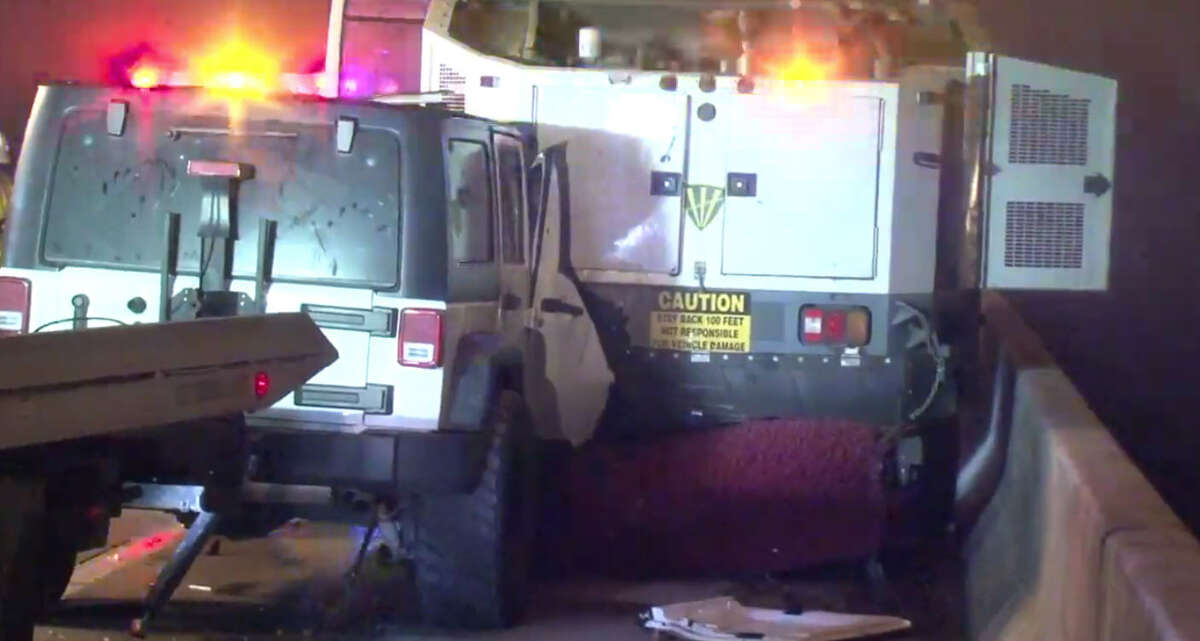A woman crashes her Jeep Wrangler into the back of a street sweeper early Wednesday morning. A combination of thick fog and dust reportedly contributed to the crash, according to authorities.