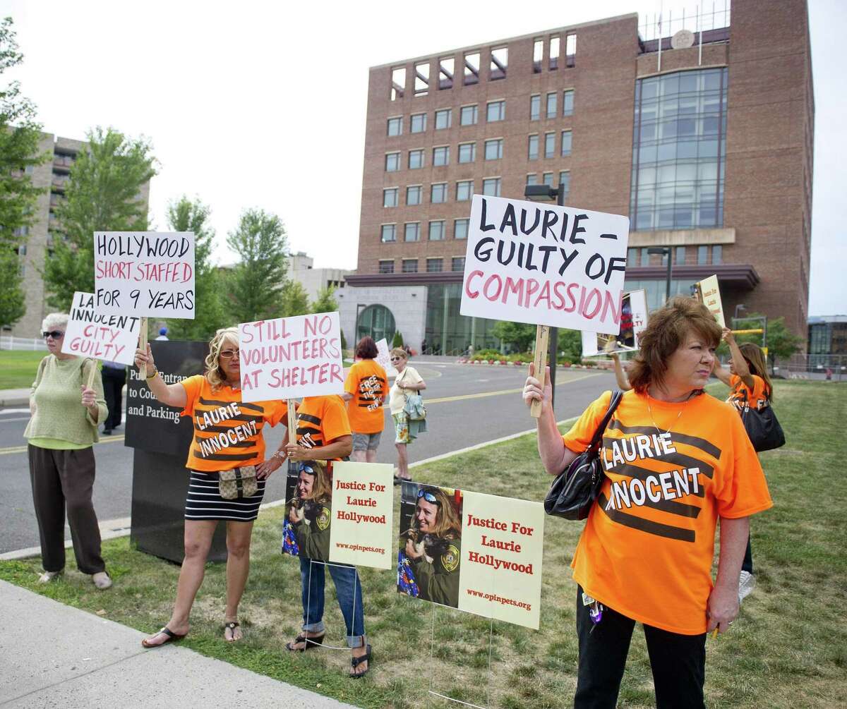 Supporters of former Stamford animal control manager Laurie Hollywood protest outside the courthouse after she was charged in 2014 with three counts of reckless endangerment.
