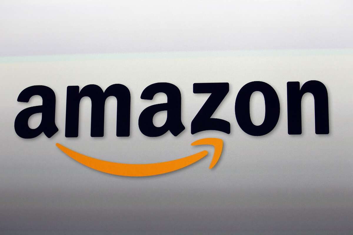 FILE - This Sept. 6, 2012, file photo shows the Amazon logo in Santa Monica, Calif. Ahead of Thanksgiving 2017, Amazon is giving Prime members their first taste of special discounts at its recently-acquired Whole Foods stores. (AP Photo/Reed Saxon, File)
