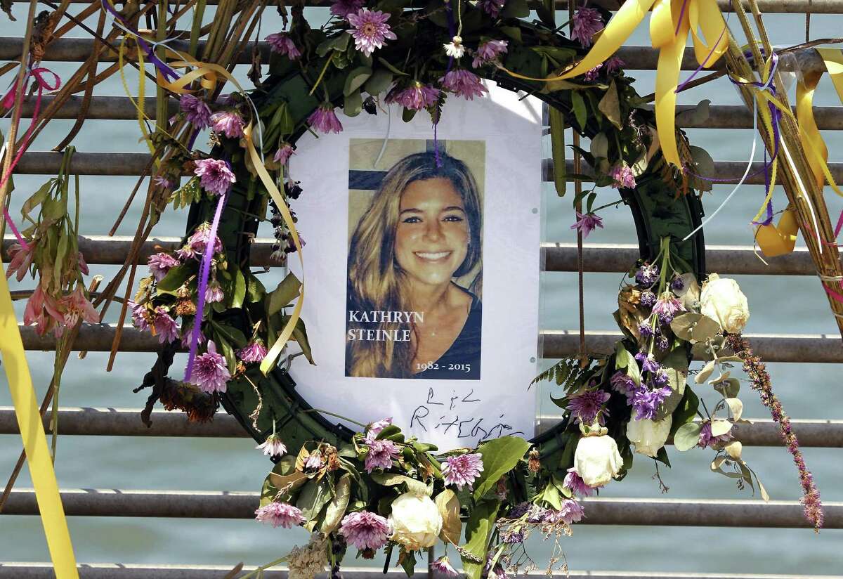 This July 17, 2015, photo shows flowers and a portrait of Kate Steinle displayed at a memorial site on Pier 14 in San Francisco.