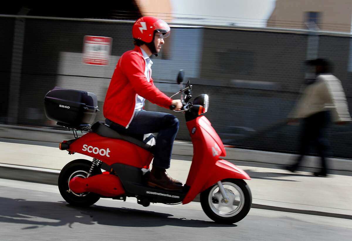 Michael Keating drives his scooter down a San Francisco alley Tuesday September 25, 2012. A San Francisco startup company wants to become the ZipCar of mopeds around the city. Michael Keating, founder and CEO, says Scoot Networks will unveil its first set of scooter stations Wednesday September 26, 2012 in the SoMa area of San Francisco, Calif.