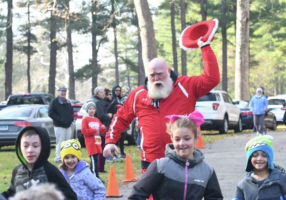 Bill Buckbee, aka Santa, cheers for the kids during the fun run of the Run Santa Run 5k Run, Walk and Kids Fun Run at Harrybrooke Park in New Milford, Saturday, Nov. 25, 2017. Funds raised this year will be donated to the park and the Juvenile Diabetes Research.