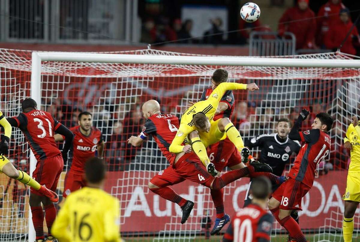 Columbus Crew’s Adam Jahn battles for the ball with Toronto FC’s Michael Bradley during the second half of an Eastern Conference MLS final playoff soccer game, Wednesday, Nov. 29, 2017 in Toronto.