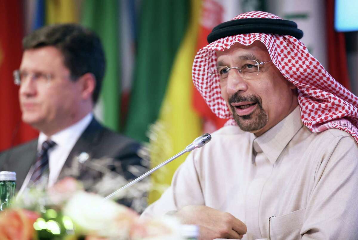 Alexander Novak, Russia's energy minister, left, looks on as Khalid Al-Falih, Saudi Arabia's energy and industry minister, speaks during a news conference after OPEC met in Vienna, Austria, on Thursday. The oil cartel and non-OPEC oil producing countries agreed to extend oil production cuts cuts of 1.8 million barrels a day through 2018.