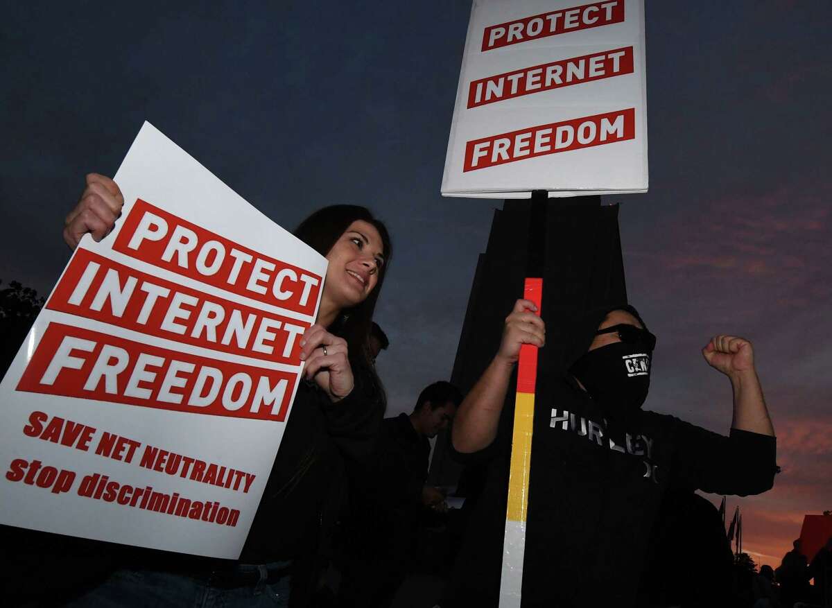 People protest during a rally to ‘Protect Net Neutrality’ as they voice their opposition to the impending FCC vote, outside the Federal Building in Los Angeles, California on Nov. 28. Organizers say “that a ruling in favor of repealing the 2015 rules could result in internet service providers prioritizing connection speeds to certain sites, such as advertisers, with access to certain websites being restricted at the service providers discretion and the opportunity to raise fees for access that otherwise is free.”