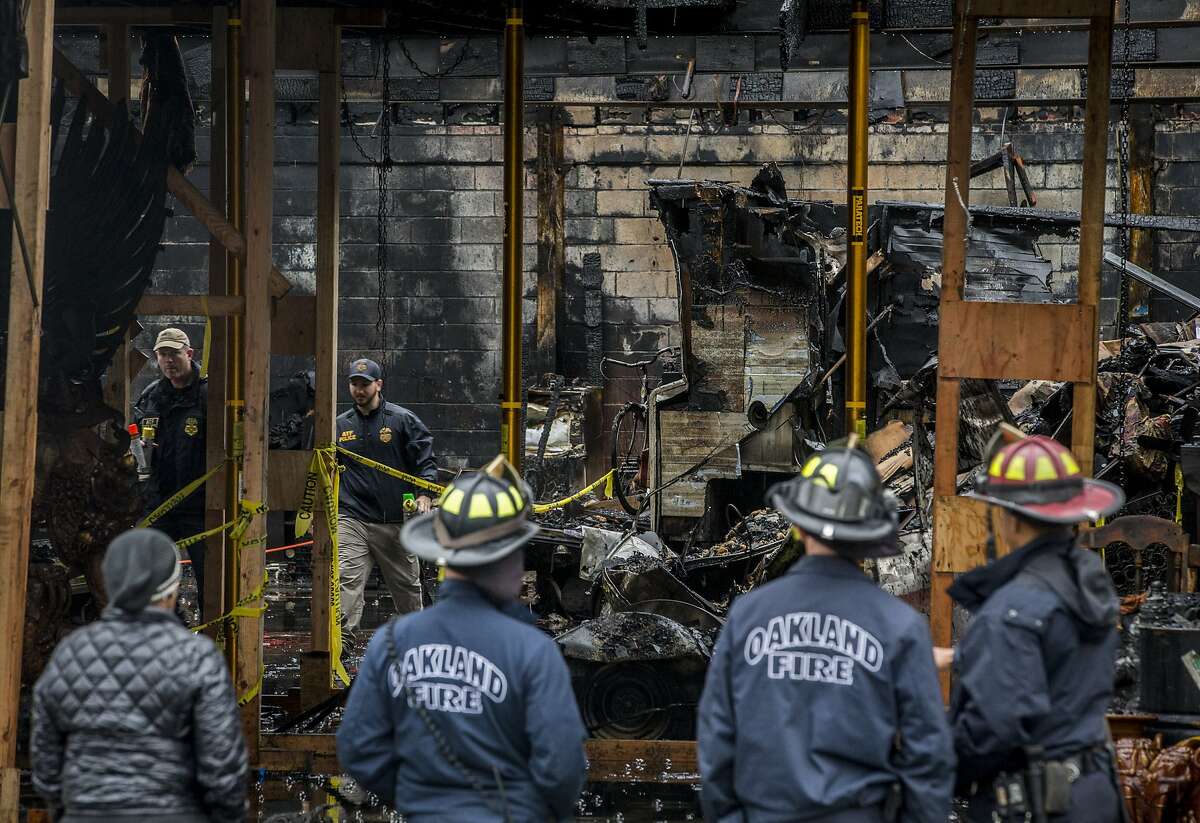AFT police officials inspect the Ghost Ship warehouse from inside as Oakland firefighters investigate outside on Saturday, Dec. 10, 2016 in Oakland, Calif. 36 people were killed when a fire broke out on Dec. 2 at the Ghost Ship warehouse on 31st Avenue and International Boulevard in Oakland's Fruitvale neighborhood. As many as 100 people were inside attending a music performance. The blaze is now the deadliest structure fire in California since the 1906 earthquake and fire. Officials said the cause of ignition is still unknown and the building had no evidence of fire sprinklers.
