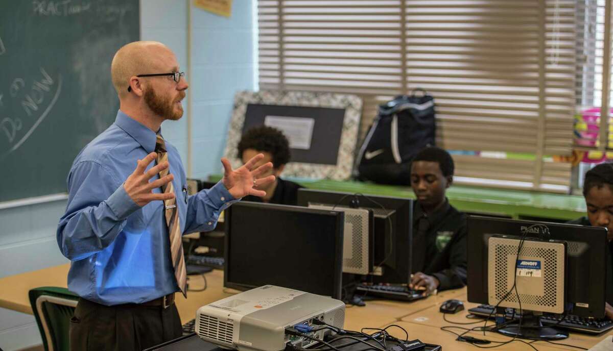 Instructor Kyle Dalton work with students during a sports marketing program at the Green Tech High Charter School Thursday Nov. 30, 2017 in Albany, NY. A new analysis shows charter schools are among the most racially segregated in the nation, but many say thatOs not a bad thing so long as they produce results. Green Tech High Charter School, pictured here, has a student body thatOs 97 percent black, but consistently produces the highest academic outcomes in the Albany City School District. (Skip Dickstein/ Times Union)