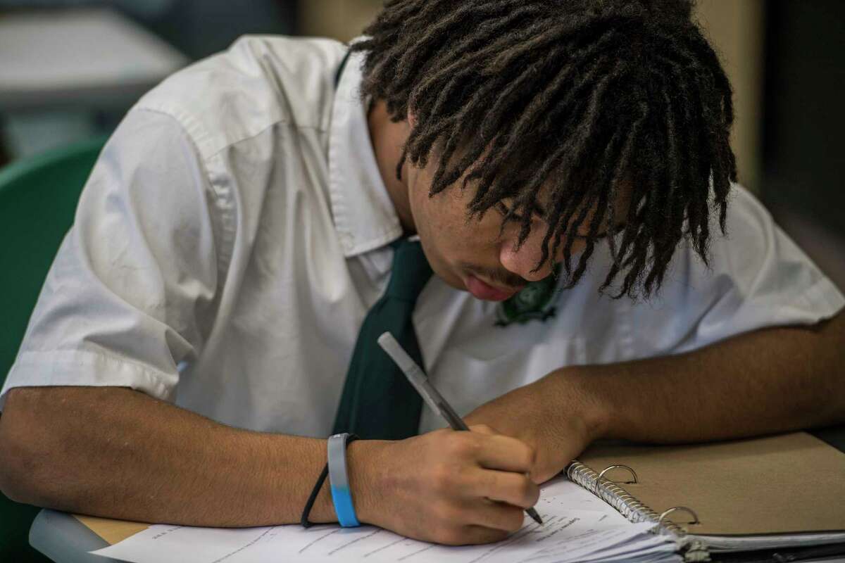 A student works intently on his classwork during a government class at the Green Tech High Charter School Thursday Nov. 30, 2017 in Albany, NY. A new analysis shows charter schools are among the most racially segregated in the nation, but many say thatOs not a bad thing so long as they produce results. Green Tech High Charter School, pictured here, has a student body thatOs 97 percent black, but consistently produces the highest academic outcomes in the Albany City School District. (Skip Dickstein/ Times Union)