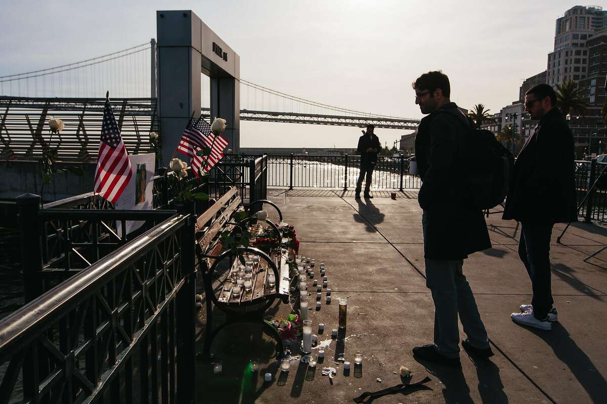 Passersby on Pier 14 in San Francisco on December 1, 2017, following the acquittal of Garcia Zarate for the murder of Kate Steinle on July 15, 2015. A memorial was erected the previous evening by a group identifying itself as the "Bay Area Alt Right."