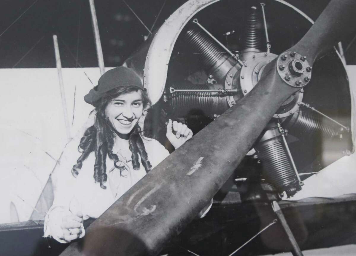 A copy of a 1916 photo hanging in the Stinson Municipal Airport terminal shows Katherine Stinson standing next to a plane at what was then Stinson Field.