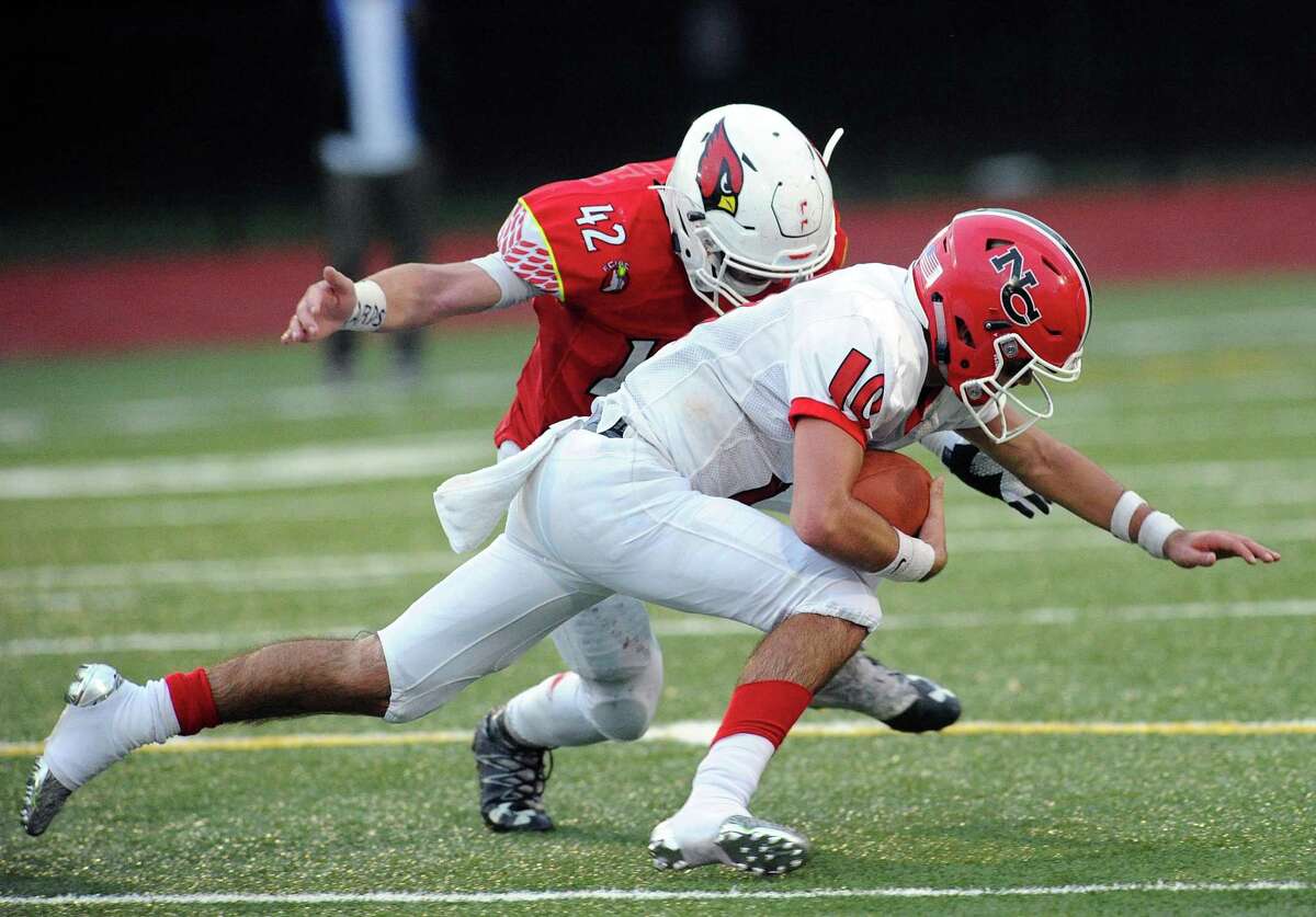 Greenwich defensive end Gramoz Bici (42) sacks New Canaan quarterback Drew Pyne during the Cardinals’ 36-21 win on Oc.t 14 at Greenwich High. Bici leads the team with 11 sacks and 87 tackles