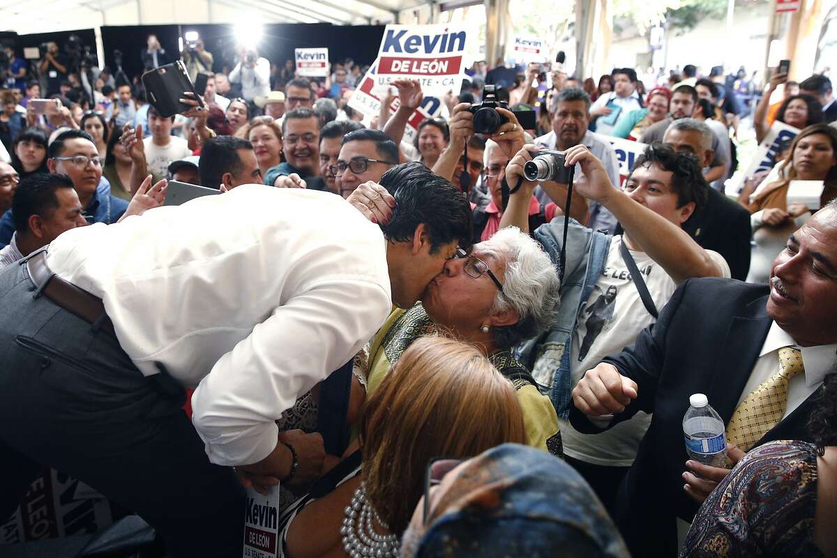 State Sen. Kevin de Leon, left, gets a kiss from a supporter during an event held to formally announce his run for U.S. Senate Wednesday, Oct. 18, 2017, in Los Angeles. (AP Photo/Jae C. Hong)