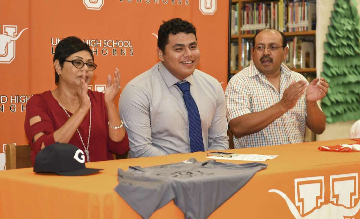 Omar Cervantes, center, celebrates with his parents Maria and Norberto Cervantes after signing his letter of intent to play baseball at Grayson County College in a ceremony Wednesday at United High School.