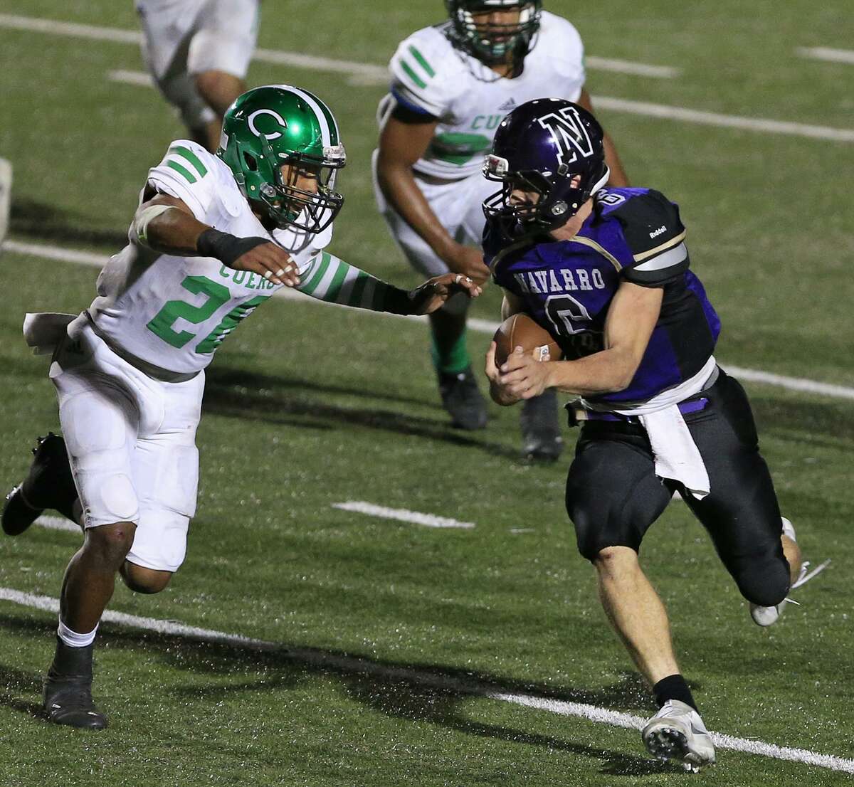 Navarro's Will Eveld looks for room around Cuero's Claeson Patton during second half action of their Class 4A Division II third-round playoff game held Friday Dec. 1, 2017 at Heroes Stadium.
