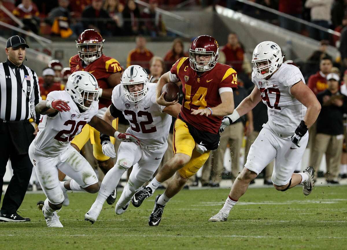 Trojan quarterback San Darnold, 14 is chased by Bobby Okereke, 20 Joey Alfieri, 32 and Dylan Jackson, 97, as the Stanford Cardinal takes on the USC Trojans in the PAC-12 championship game at Levi's Stadium, in Santa Clara Calif. on Fri. December 1, 2017.