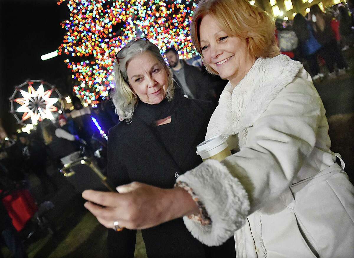 Mary McCarthy, of Wallingford takes a selfie with her sister Monica McCarthy of Prospect at the annual Christmas tree lighting on the historic New Haven Green, Thursday, Nov. 30, 2017.