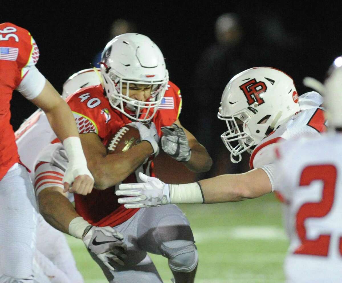 Greenwich High running back Tysen Comizio tries to break a tackle against Fairfield Prepduring a Class LL state quarterfinal game Tuesday in Greenwich.