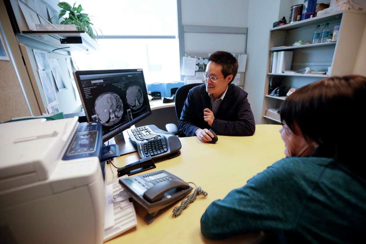 ﻿Alison Cairnes, right, looks at images with her doctor, Shumei Kato, at the University of California in San Diego. Tumor profiling Cairnes' cancer genes helped Kato identify an effective treatment for her gastric cancer.