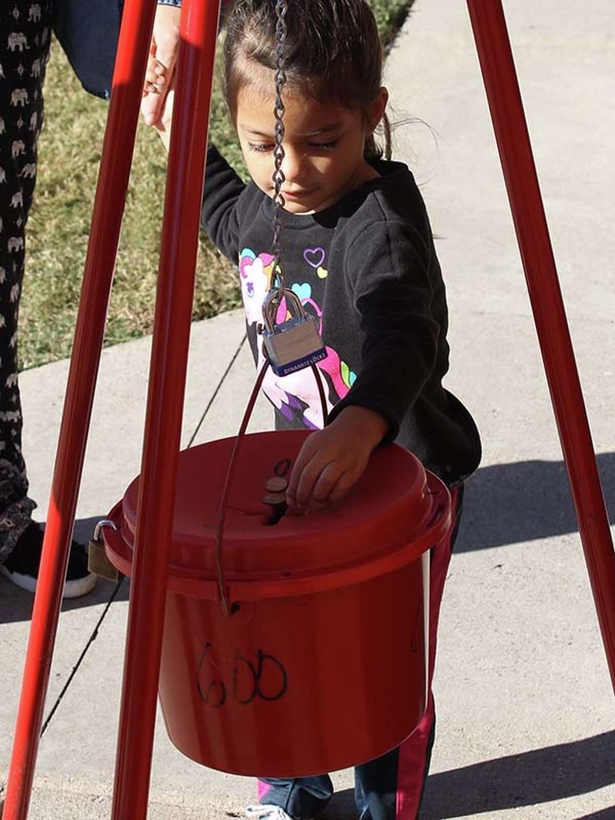 Jubilee Longoria donates to the Salvation Army red kettle.