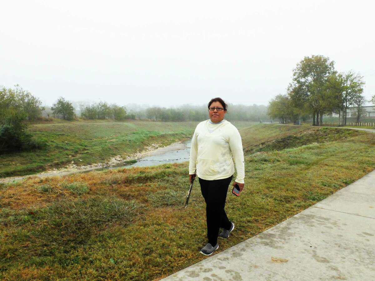 Maria Gomez walks along the White Oak Bayou Greenway near De Soto Street on Nov. 29, 2017.