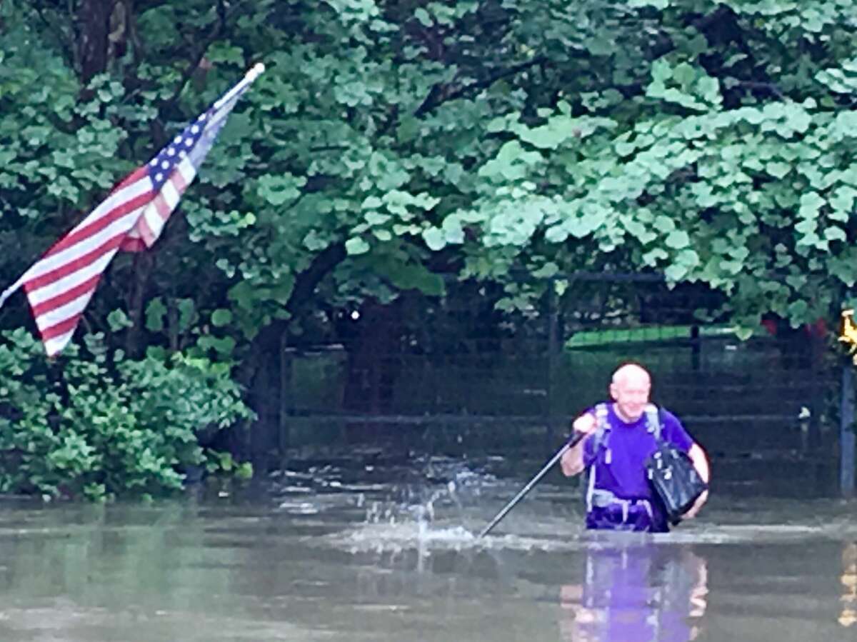 Former Houston Mayor Bill White leaves his flooded house off Buffalo Bayou during Hurricane Harvey in this photo taken by a neighbor.