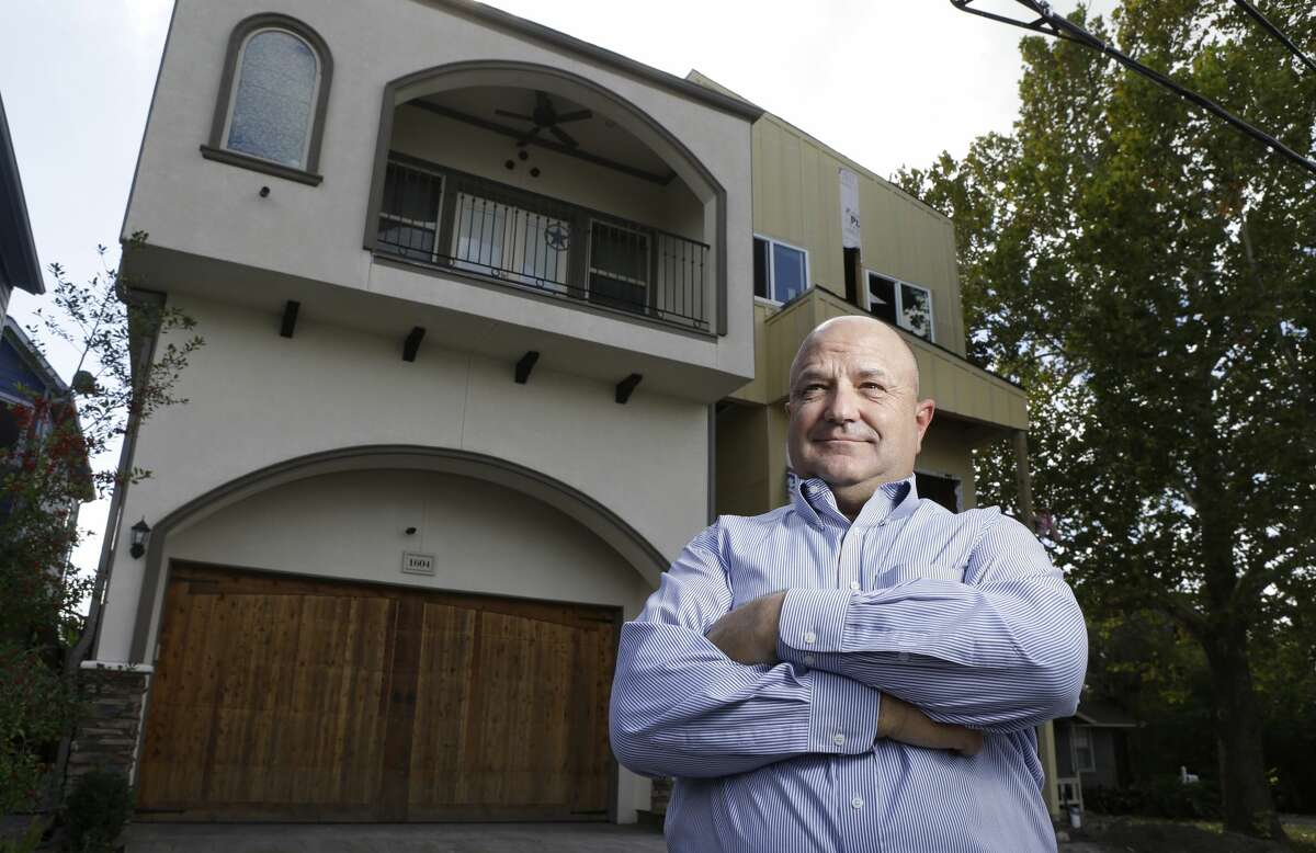 Bruce Norcini poses in Houston near town homes that now stand on land along W. 21st Street that he once owned. In 2006, the city prohibited building in floodways. Overnight, it rendered Norcini's property on W. 21st Street worthless. Norcini and others sued and forced the city to rewrite the ordinance.