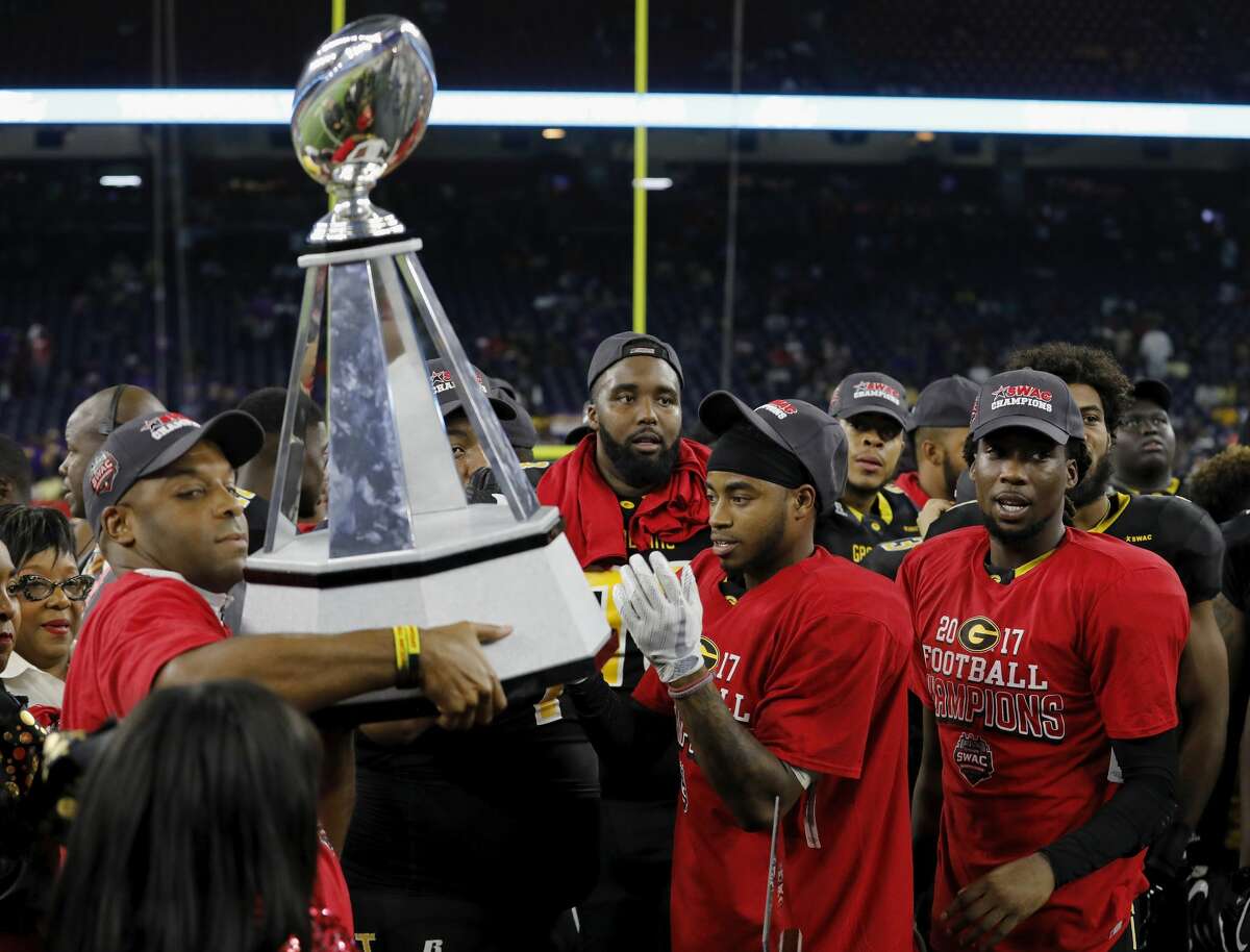The Grambling State Tigers celebrate as head coach head coach Broderick Fobbs holds the championship trophy after the SWAC Championship football game between the Alcorn State Braves and the Grambling State Tigers at NRG Stadium in Houston, TX on Saturday, December 2, 2017.