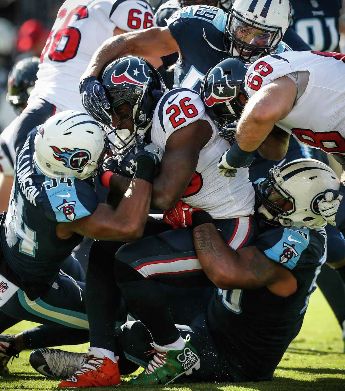Houston Texans running back Lamar Miller (26) is stopped at the line of scrimmage by Tennessee Titans inside linebacker Avery Williamson (54) during the first quarter of an NFL football game at Nissan Stadium on Sunday, Dec. 3, 2017, in Nashville.