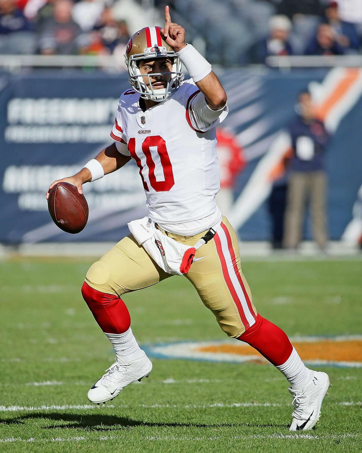 CHICAGO, IL - DECEMBER 03: Jimmy Garoppolo #10 of the San Francisco 49ers rolls out and instructs a receiver agains the Chicago Bears at Soldier Field on December 3, 2017 in Chicago, Illinois. (Photo by Jonathan Daniel/Getty Images)