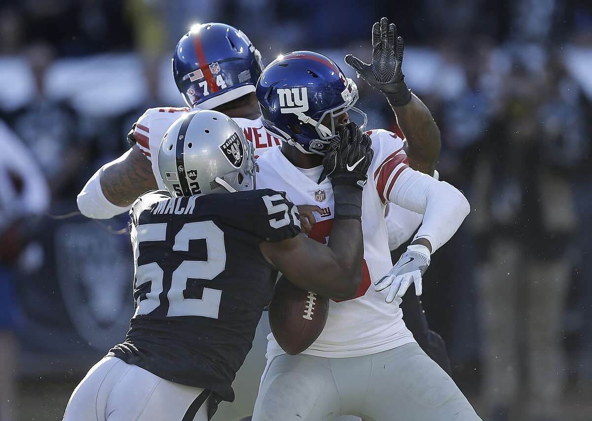 Oakland Raiders defensive end Khalil Mack (52) sacks and forces a fumble  from New York Giants quarterback Geno Smith during the first half of an NFL  football game in Oakland, Calif., Sunday