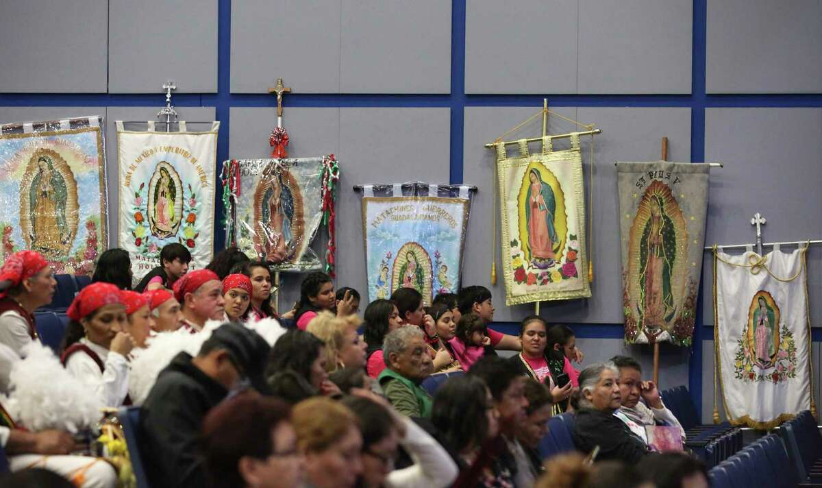 Lady of Guadalupe flags are lean against the George R. Brown Conventional Center auditorium wall as the participants arriving at the center honoring Feast Day of Our Lady of Guadalupe on Sunday, Dec. 3, 2017, in Houston. ( Yi-Chin Lee / Houston Chronicle )
