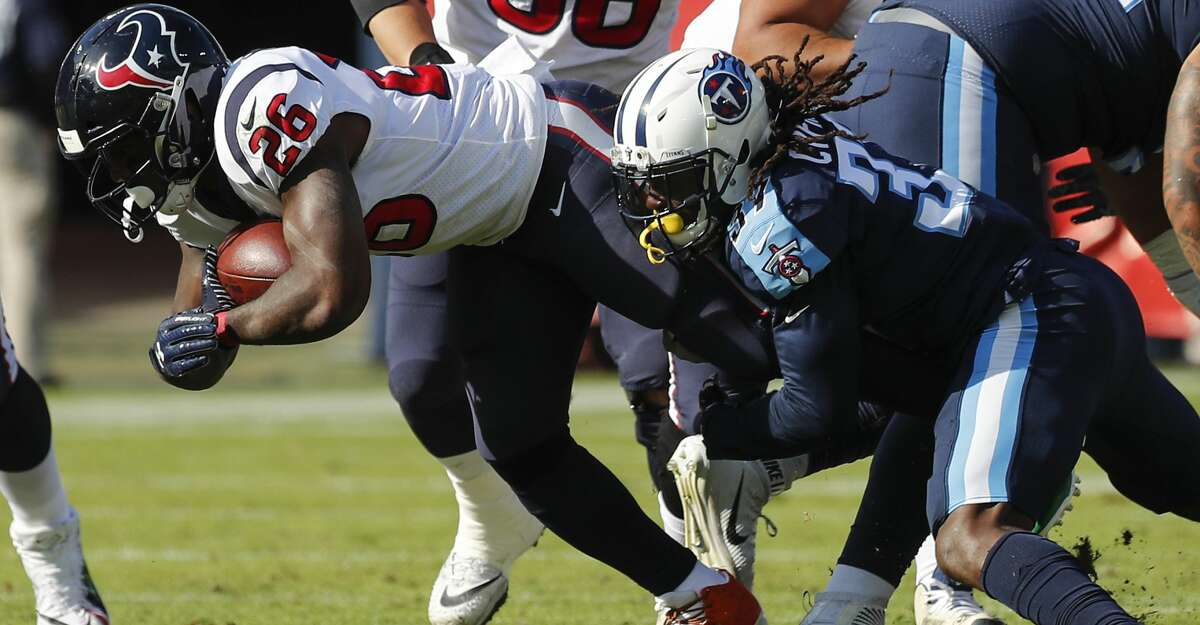 Houston Texans running back Lamar Miller (26) is stopped by Tennessee Titans strong safety Johnathan Cyprien (37) during the first quarter of an NFL football game at Nissan Stadium on Sunday, Dec. 3, 2017, in Nashville. ( Brett Coomer / Houston Chronicle )