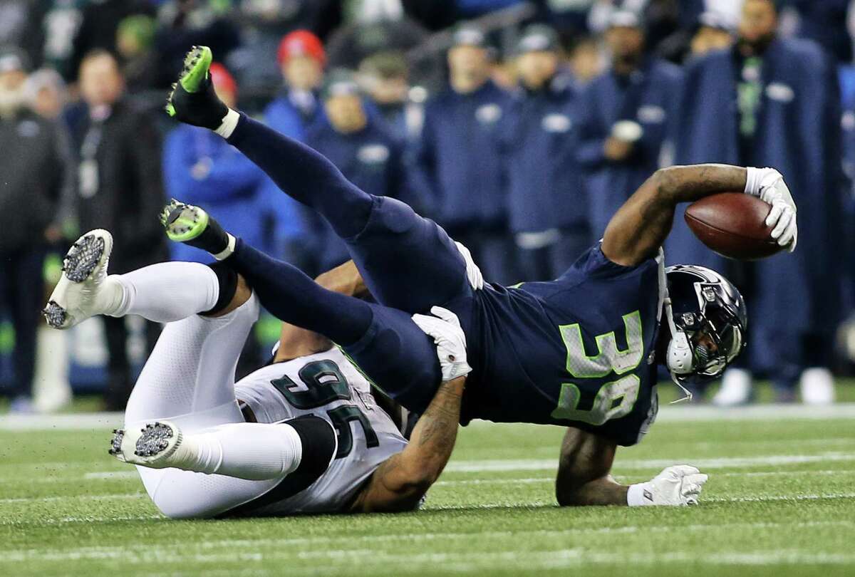 Seahawks running back Mike Davis (39) is tackled by Eagles linebacker Mychal Kendricks (95) during the first half of Seahawks game against the Philadelphia Eagles, Sunday, Dec. 3, 2017, at CenturyLink Field. (Genna Martin/seattlepi.com)