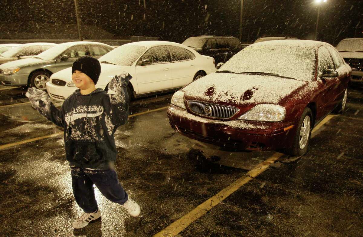 Mario Hernandez Jr., 6, enjoys his first snow fall as he plays with the snow at Affordable Cars & Trucks, 5715 I-45, where his dad, Mario Hernandez, Sr. works shown Wednesday, Dec. 10, 2008, in Houston.