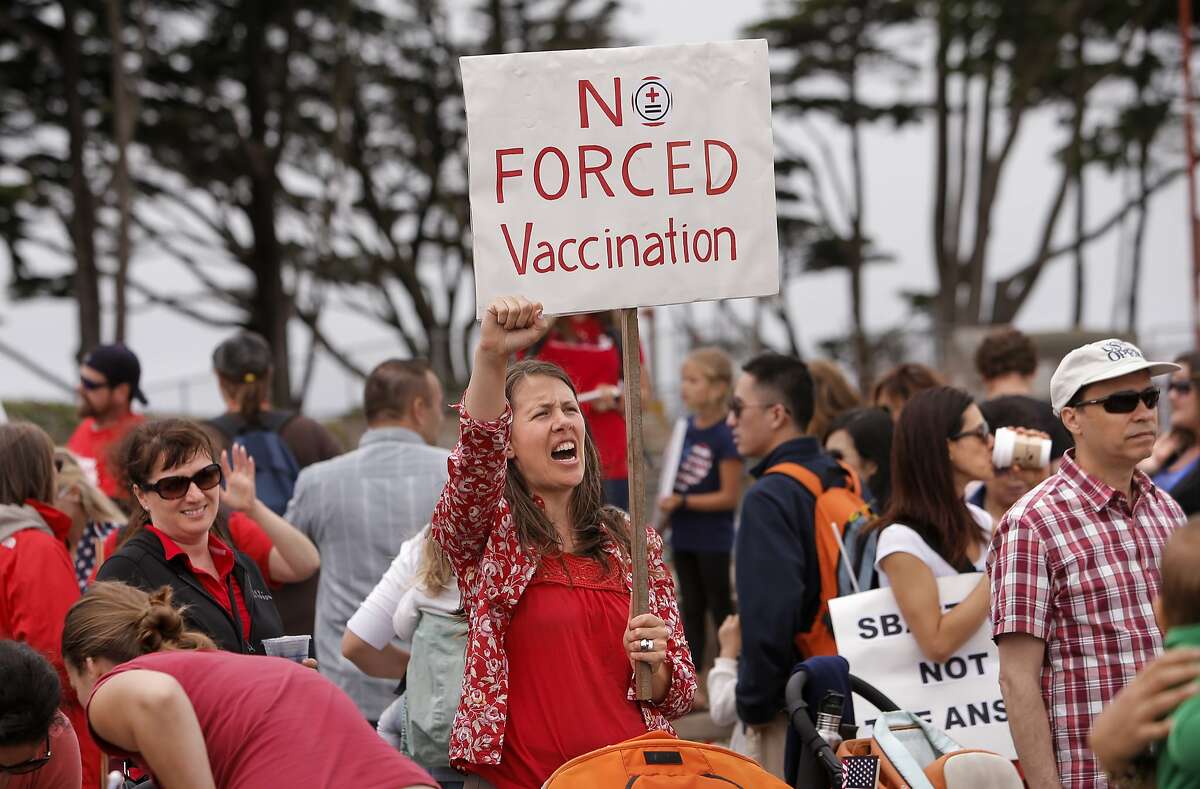 A crowd protests a law banning personal exemptions from vaccinations in 2015.