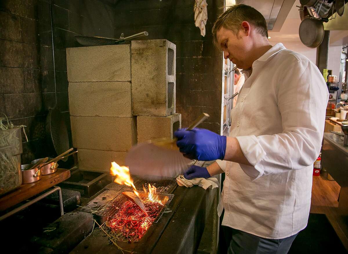 Chef Josh Skenes cooks Bonito at Saison in San Francsico, Calif., on Wednesday, May 14th, 2014.