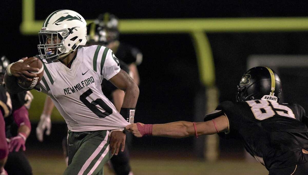 New Milford's Kendall Greene (6) is in the grasp of Joel Barlow's Henry Shaban (85).