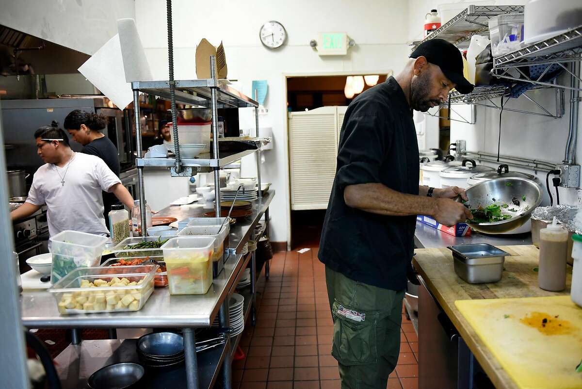 Owner Nigel Jones works with his staff in the kitchen of his restaurant Kingston 11, in Oakland, CA, on Thursday November 30, 2017.